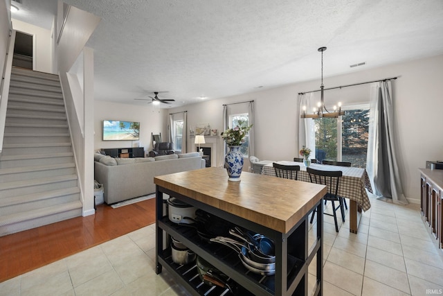 dining room with visible vents, plenty of natural light, a textured ceiling, and light tile patterned floors