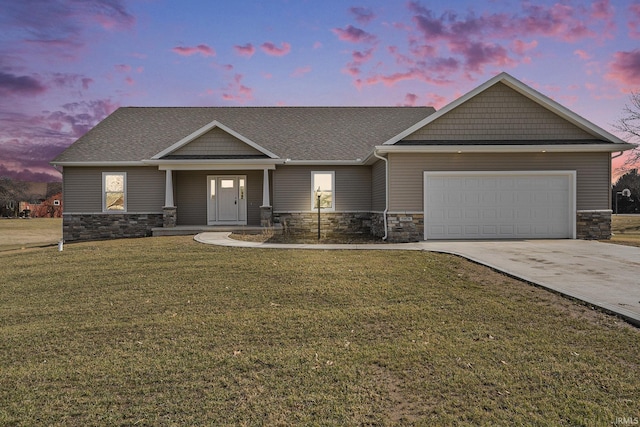 craftsman-style house featuring a garage, a front yard, stone siding, and driveway