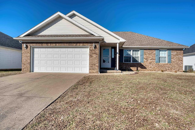 ranch-style house with driveway, an attached garage, central air condition unit, a front lawn, and brick siding