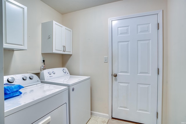 washroom with cabinet space, independent washer and dryer, and baseboards