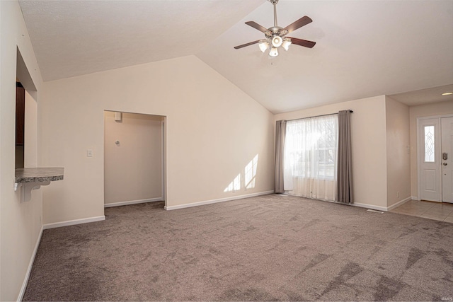 unfurnished living room featuring lofted ceiling, ceiling fan, baseboards, and carpet flooring