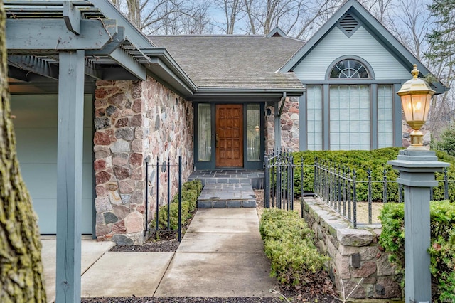 property entrance with stone siding and roof with shingles