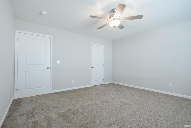 empty room featuring carpet, ceiling fan, and baseboards