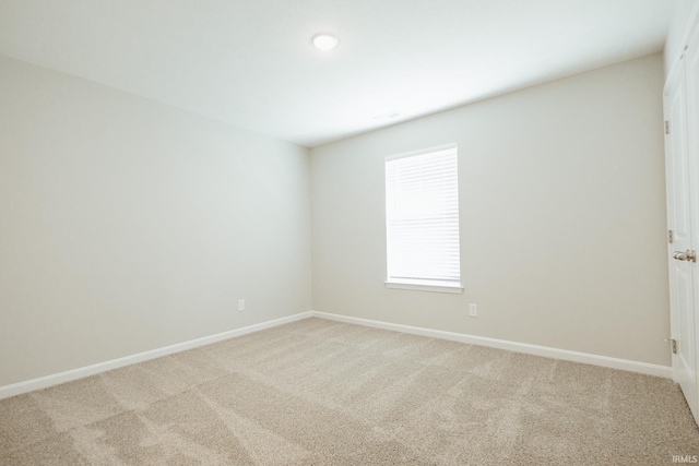 carpeted empty room with baseboards