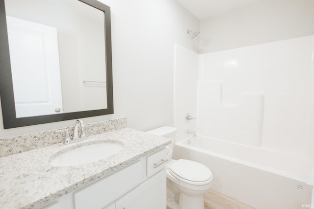 bathroom with shower / tub combination, vanity, and toilet