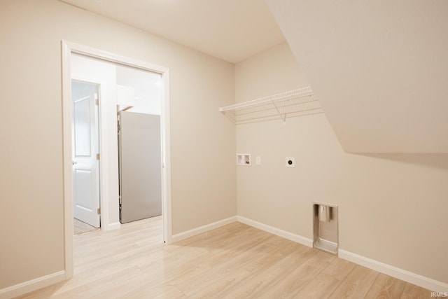 laundry room featuring laundry area, light wood finished floors, baseboards, hookup for a washing machine, and hookup for an electric dryer