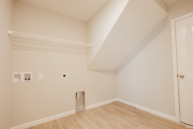 laundry area featuring laundry area, baseboards, hookup for a washing machine, hookup for an electric dryer, and light wood-type flooring