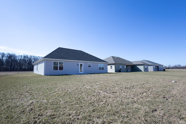 view of front of house with a front yard and roof with shingles