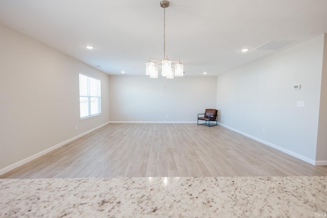 unfurnished room with baseboards, wood finished floors, and recessed lighting