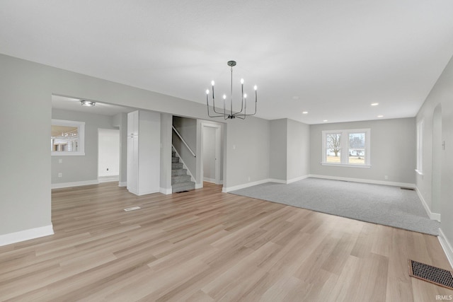 interior space featuring recessed lighting, visible vents, baseboards, stairs, and light wood finished floors