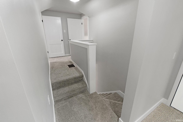 stairway featuring carpet flooring, visible vents, and baseboards