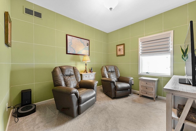 living area featuring carpet flooring and visible vents