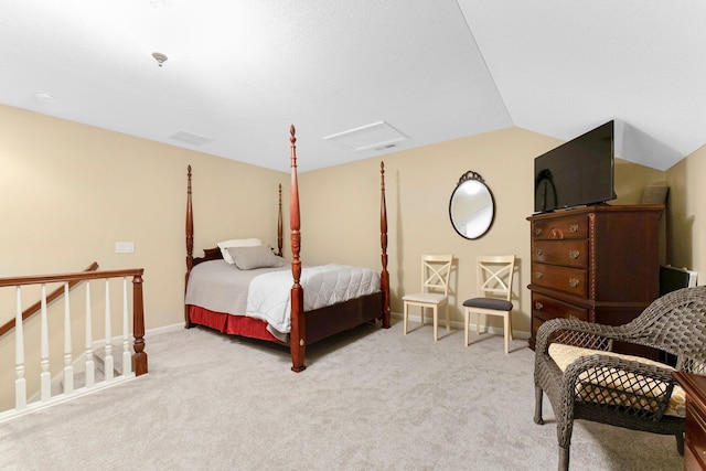 bedroom featuring lofted ceiling, carpet, attic access, and baseboards