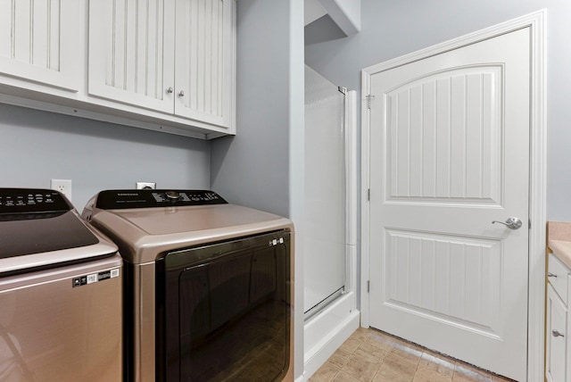 laundry room with cabinet space and separate washer and dryer