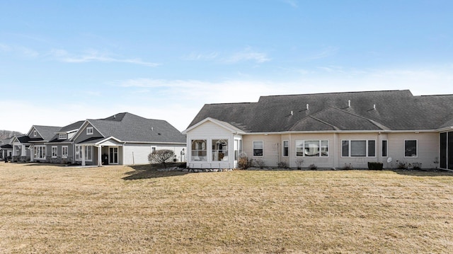 rear view of property featuring a yard