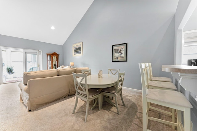 dining area featuring baseboards, high vaulted ceiling, recessed lighting, and light colored carpet