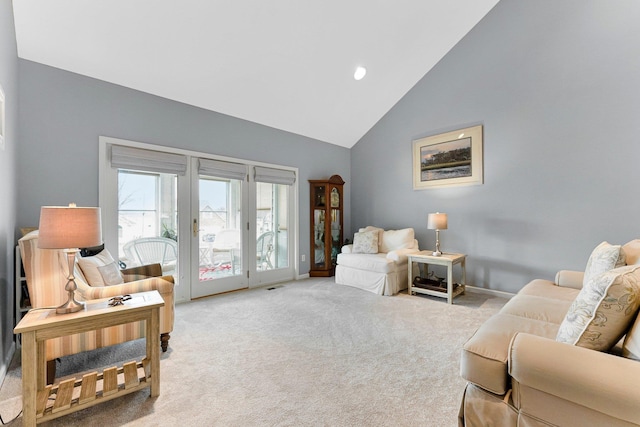 living room with high vaulted ceiling, light carpet, visible vents, and baseboards