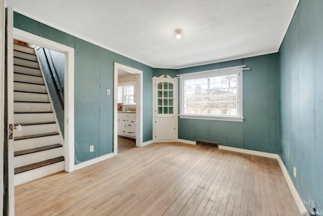 interior space with stairs, wood-type flooring, visible vents, and plenty of natural light