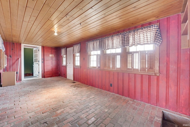 unfurnished sunroom featuring wooden ceiling