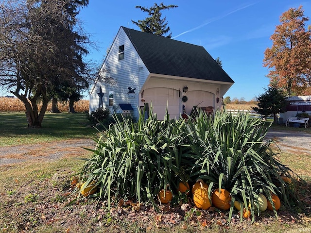 view of property exterior with a garage and roof with shingles