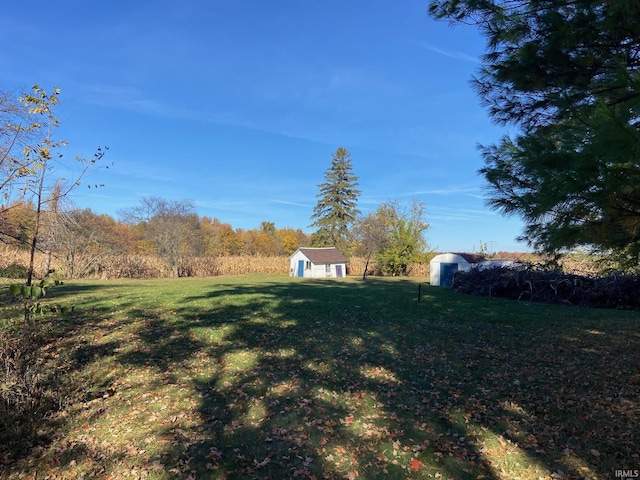 view of yard with an outbuilding and a storage shed