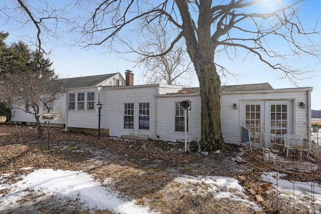 exterior space with a chimney and french doors