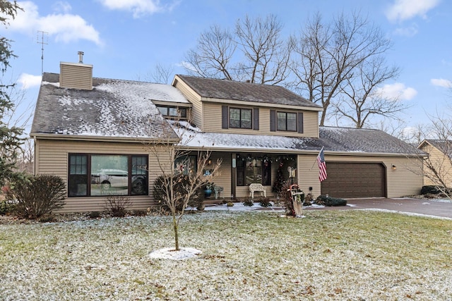 traditional home with a porch, a garage, driveway, a front lawn, and a chimney