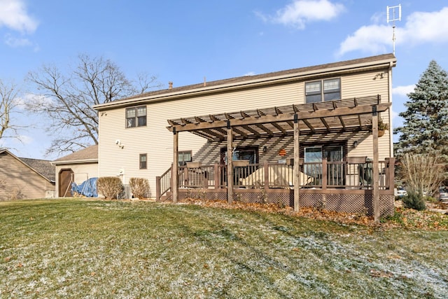 back of property featuring a lawn, a wooden deck, and a pergola