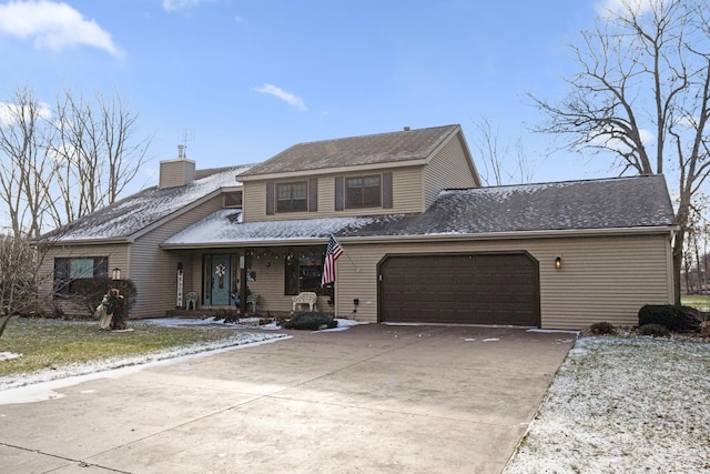 traditional home featuring a garage, a chimney, and concrete driveway