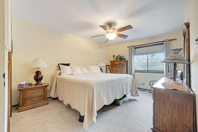 bedroom featuring light carpet and a ceiling fan