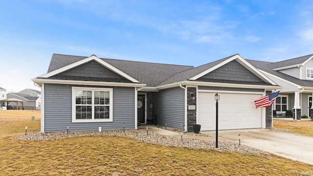 view of front of home with a garage, a front yard, and concrete driveway