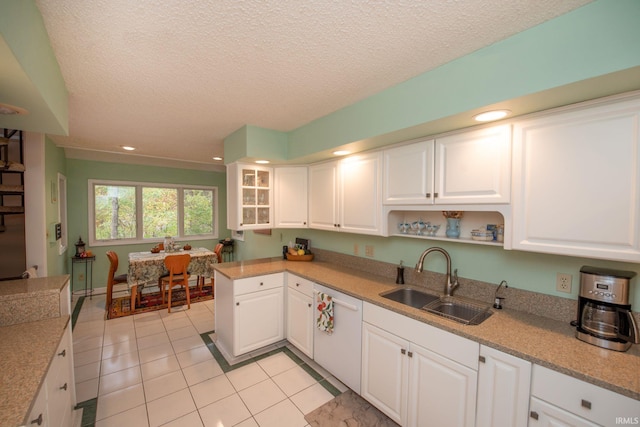 kitchen featuring light tile patterned floors, a textured ceiling, recessed lighting, a sink, and white cabinetry