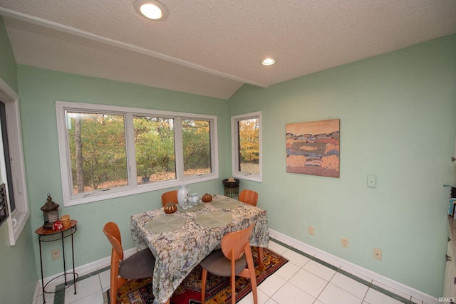 dining area featuring vaulted ceiling, recessed lighting, light tile patterned flooring, and baseboards