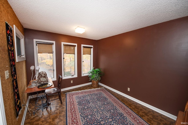 office featuring a textured ceiling and baseboards