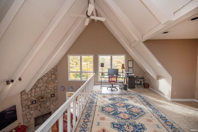 carpeted office with high vaulted ceiling, beam ceiling, and baseboards