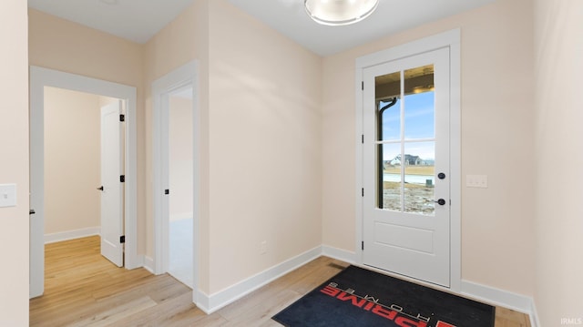 entryway with baseboards and light wood-style floors