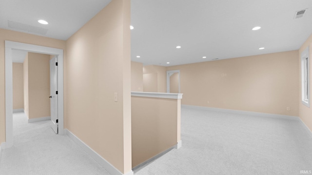 hall with light carpet, recessed lighting, baseboards, and an upstairs landing