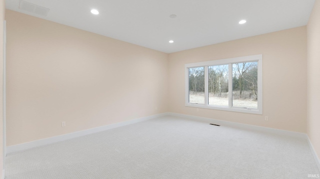 empty room featuring light carpet, baseboards, visible vents, and recessed lighting