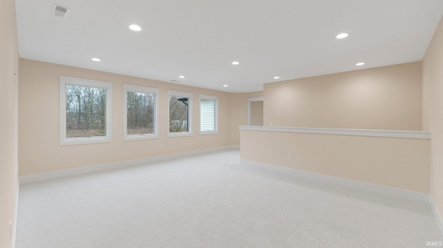 unfurnished room featuring light carpet, baseboards, and recessed lighting