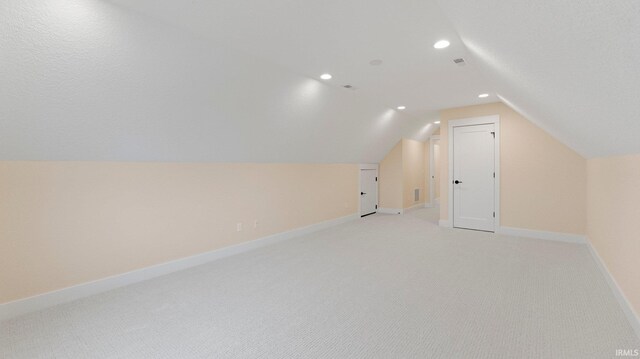 bonus room featuring recessed lighting, baseboards, vaulted ceiling, and light colored carpet