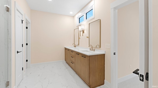 full bathroom featuring marble finish floor, double vanity, a sink, and baseboards