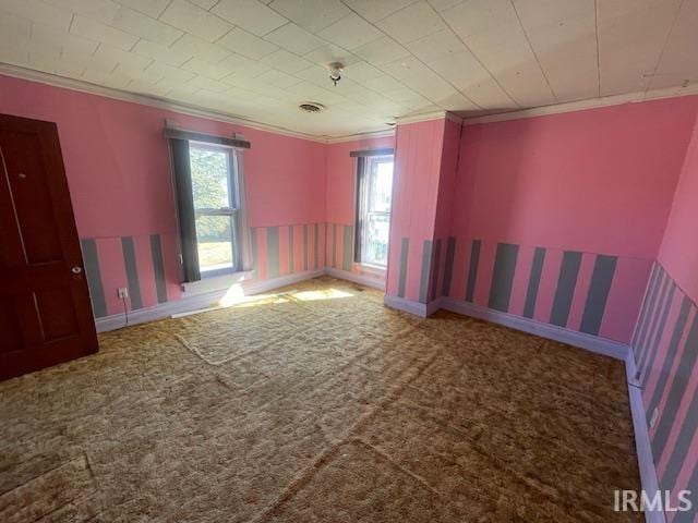 carpeted spare room with baseboards, ornamental molding, and wallpapered walls