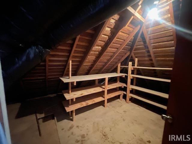 unfinished attic featuring an upstairs landing