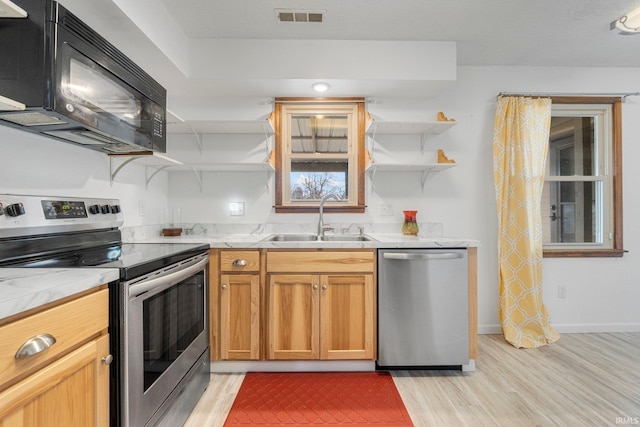 kitchen with open shelves, visible vents, appliances with stainless steel finishes, light wood-style floors, and a sink