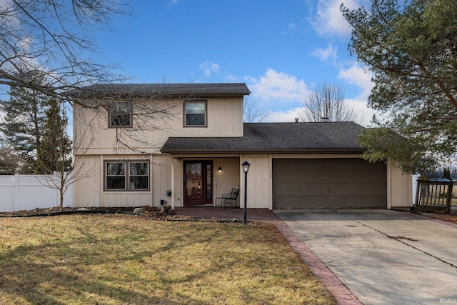 traditional-style house with a garage, concrete driveway, a front lawn, and fence