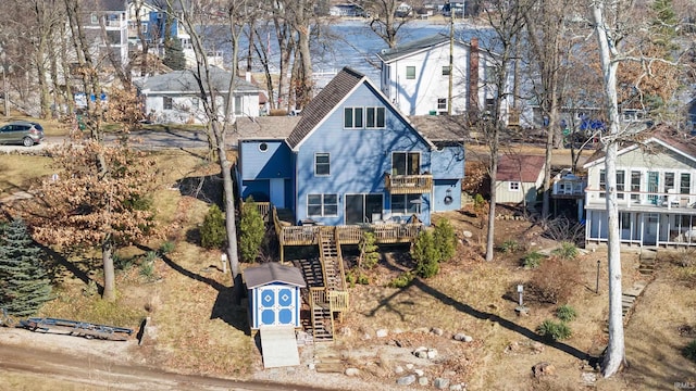 rear view of property featuring a residential view and stairway