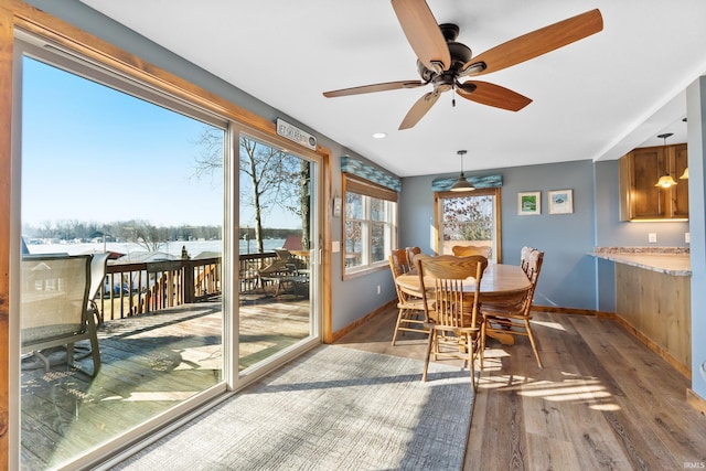 sunroom featuring a ceiling fan