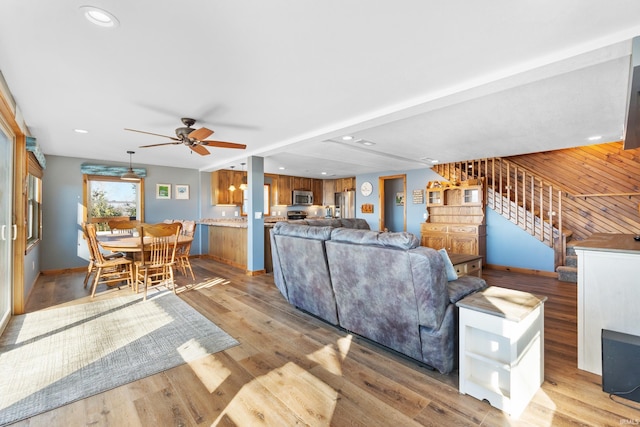 living area featuring light wood-style floors, recessed lighting, stairway, and a ceiling fan