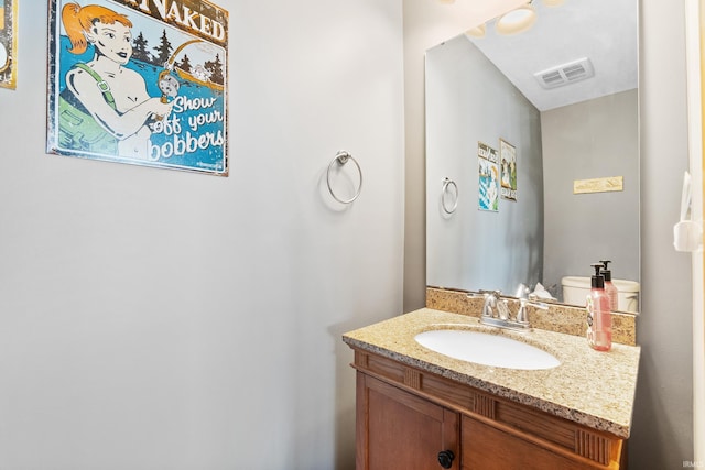 half bathroom with visible vents and vanity