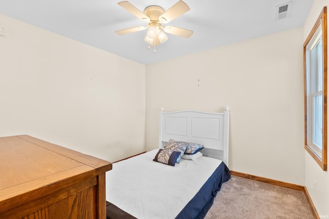 carpeted bedroom featuring visible vents, ceiling fan, and baseboards